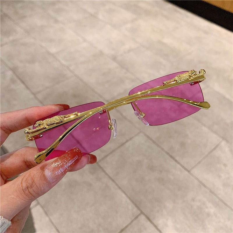 Sunglass Lover trendy rimless sunglasses for women gold frame pink lenses decorative top accents held by hand