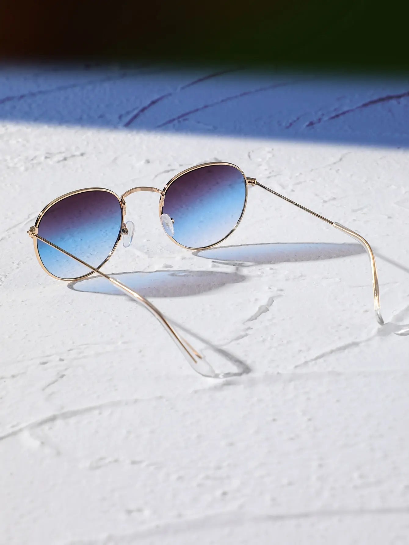 Oval sunglasses for men by Sunglass Lover with gold metal frame and blue gradient lenses