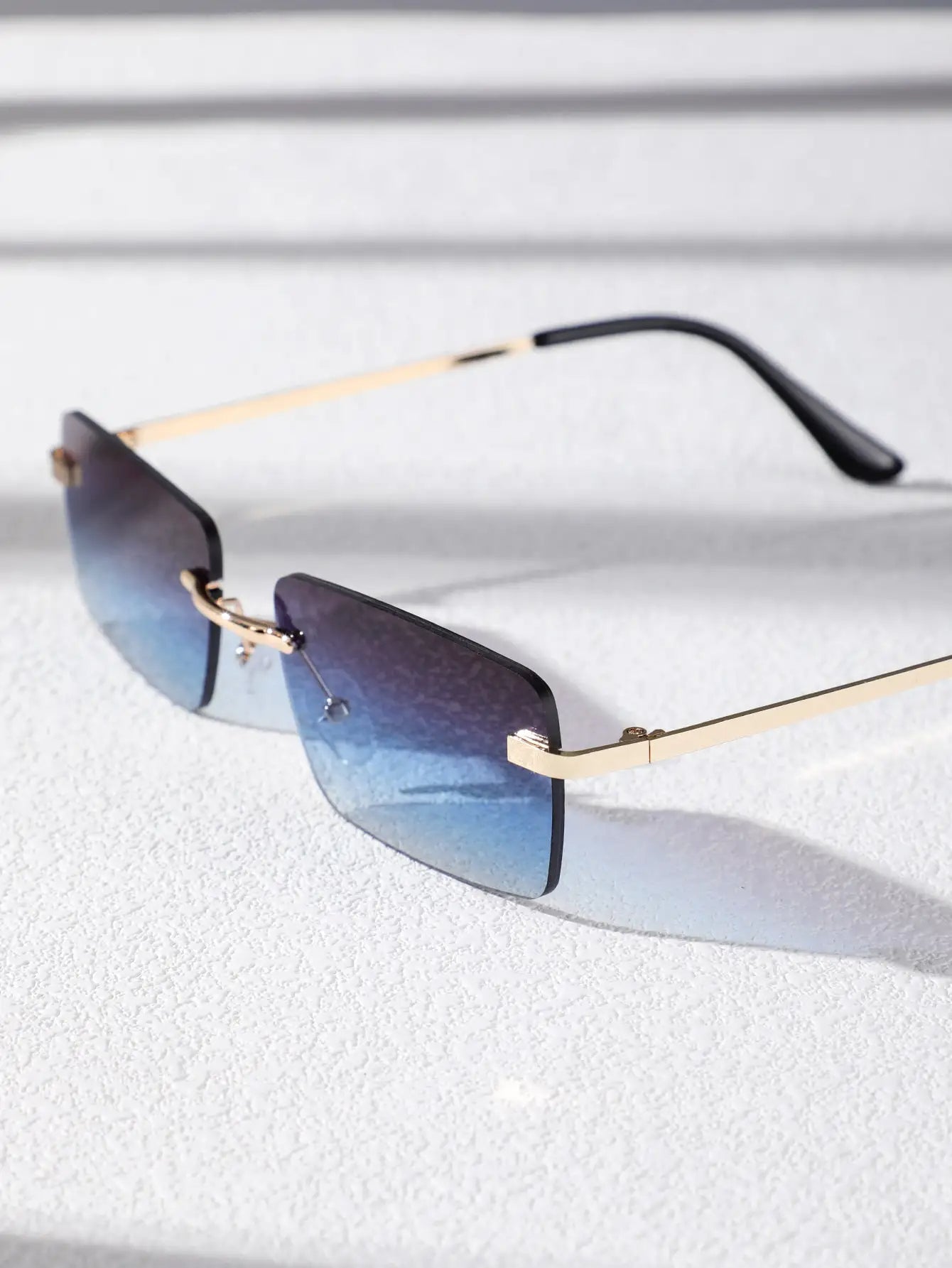 Bondex rimless sunglasses with gradient blue lenses and gold temples by Sunglass Lover