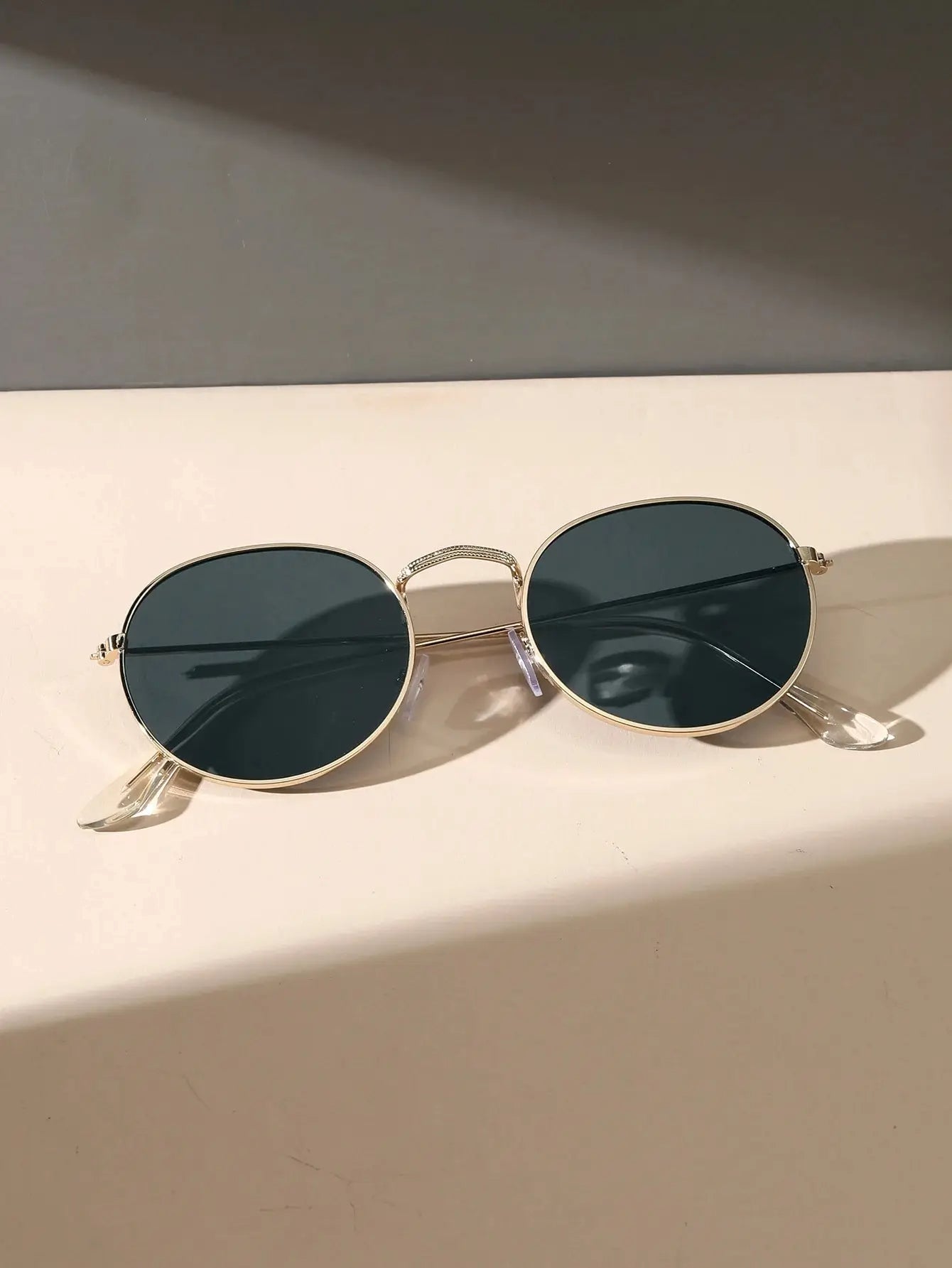 Oval sunglasses for men in gold metal frame with dark lenses by Sunglass Lover