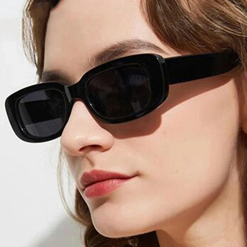 Close-up of a woman wearing black Jimmy Rectangle sunglasses by Sunglass Lover
