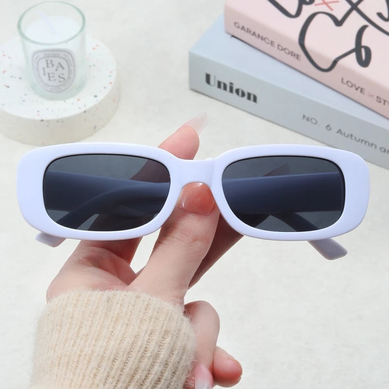 Jimmy Rectangle sunglasses by Sunglass Lover in white frame with dark lenses held in hand