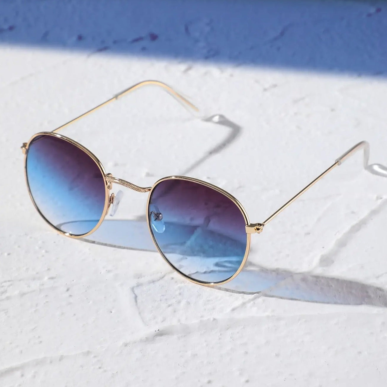 Oval sunglasses for men by Sunglass Lover with gold frame and blue gradient lenses