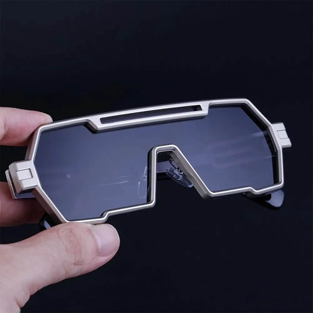 Sunglass Lover square vintage punk sunglasses with silver geometric metal frame and dark smoked lenses held in hand