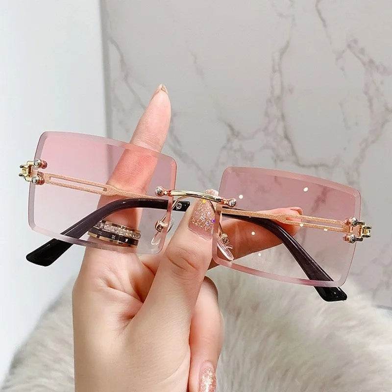 Sunglass Lover rimless sunglasses for men with pink rectangular lenses gold bridge and black temple tips