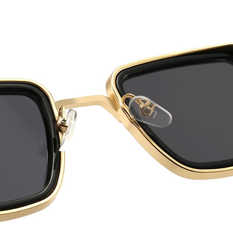 Close-up of Sunglass Lover square vintage steampunk sunglasses with black lenses and gold frame