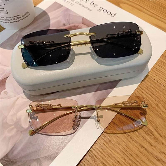Sunglass Lover trendy rimless sunglasses for women black and rose tinted lenses with gold bridge on white case