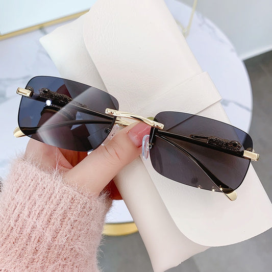 Sunglass Lover rimless sunglasses for men with black rectangular lenses and gold accents