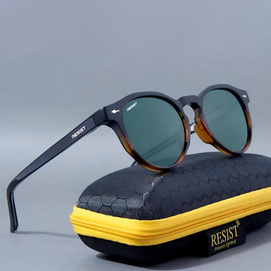 Marc oval green sunglasses with tortoiseshell round frame and dark green lenses resting on black case with yellow zipper