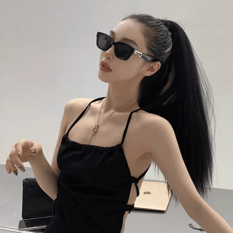 Sunglass Lover black rectangle frame retro cat eye sunglasses for women worn by model with ponytail