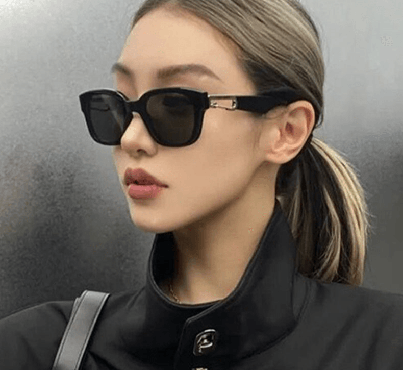 Black rectangle sunglasses on woman in leather jacket by Sunglass Lover retro cat eye sunglasses for women with gold hinge detail