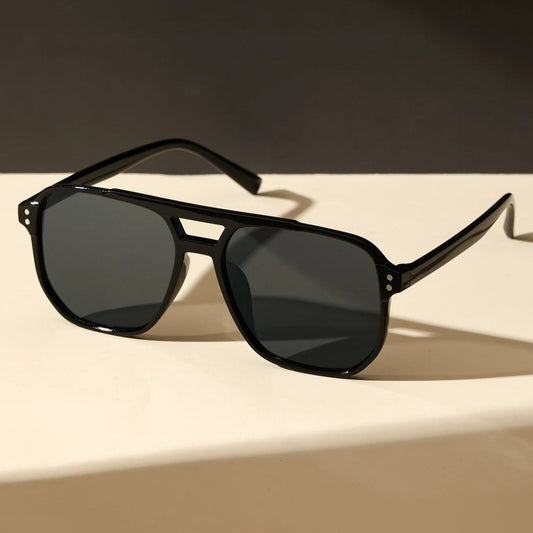 Sunglass Lover black square geometric street sunglasses with dark lenses on white surface